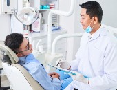 A dentist consults with a patient
