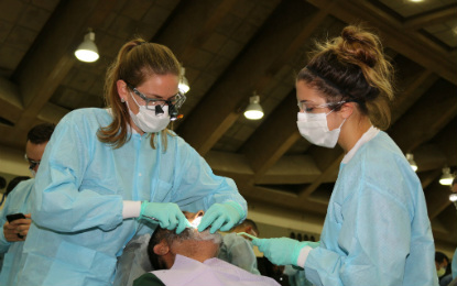 Student Volunteers assist a patient during the 2017 Mission of Mercy