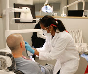 A dentist working with a patient in a dental chair