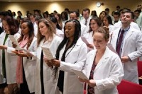 A group of dental grads receive their white coats