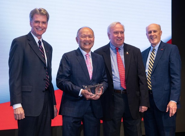 Henry Lee (second from left) is joined by (from left) UMSOD Dean Mark Reynolds, UMB Foundation Board of Trustees Chair Harry Knipp, and UMB President Bruce Jarrell after receiving the Distinguished Service Award.