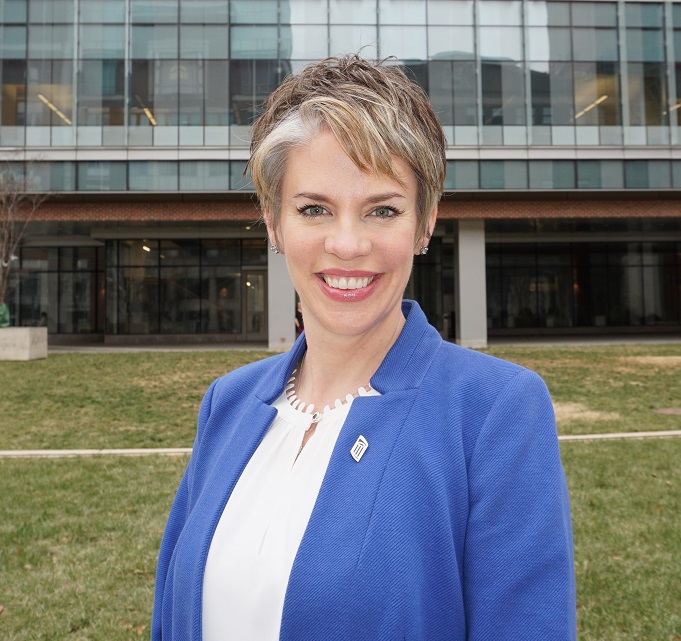 Dr. Noonan standing outside in front of a building