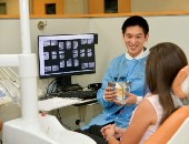 A dentist consults with a patient