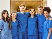 A group of dental students pose in scrubs