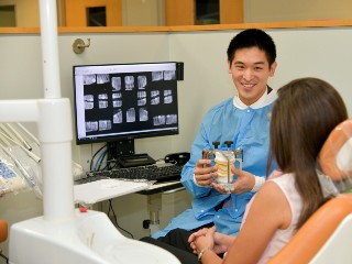 A dentist consults with a patient