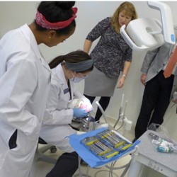 Two dental hygiene students preparing instruments