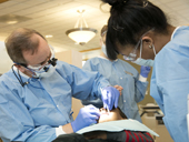 Two periodontists performing a dental procedure