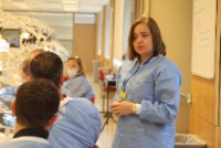 A teacher instructs students in a simulation lab
