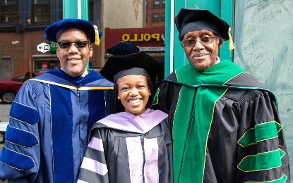 Sarah Nia Coleman, DDS '22, (center) was hooded by her father Charles Coleman, PhD (left) and her grandfather William Brown, MD (right).