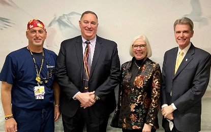 (From left) Clinical Instructor Adam Eisner, DDS ’89; Gordon Bell, DDS ’89; Holly Bell; and Mark Reynolds, DDS ’86, PhD, dean of UMSOD