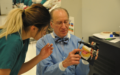 Ivan Fried instructing student in prosthodontics course