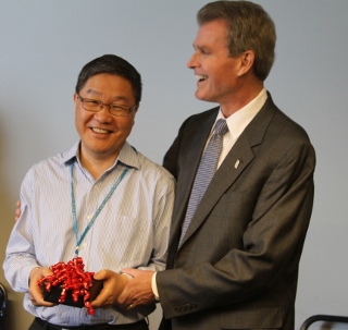 Dean Mark Reynolds presents Dr. Li Mao with a parting gift