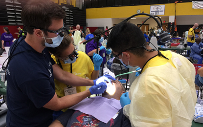 UMSOD students treat patient at the Mission of Mercy Waldorf event