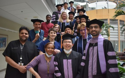 When emergency surgery prevented Umar Mian, DDS ’22 (front row, far right), from attending UMSOD’s Honors Convocation on May 20, classmates, and faculty and family members gathered for a surprise ceremony at the University of Maryland Medical Center.