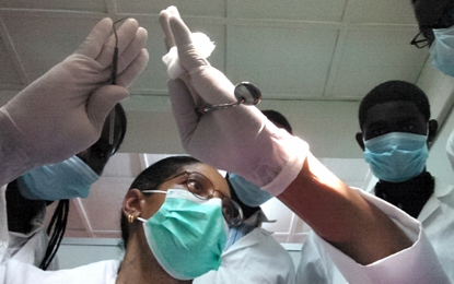 Valli Mees, DDS, MS, RDH, provides instruction to Rwandan dental students