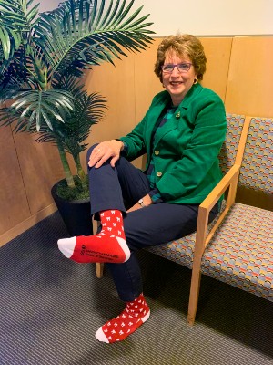 A woman wearing a pair of colorful socks