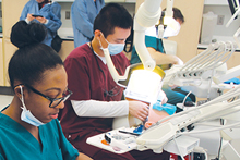 Picture of featured students working in the SIM lab