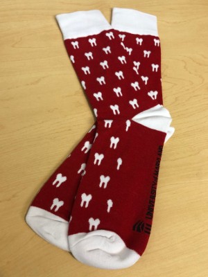 A pair of red socks with a dental tooth pattern.