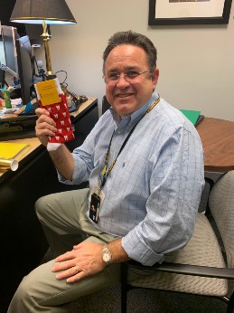 Howard Freundlich, DDS Class of 1980, holding up a pair of socks