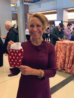 Leslie Grant, DDS Class of 1986, holding up a pair of colorful socks