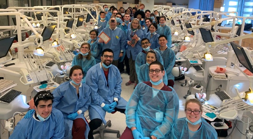 Students and faculty pose in UMSOD's clinical simulation lab