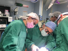 Two dental residents provide a patient with care