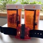 Two pill bottles and an activity tracker