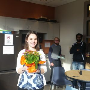 Dr. Cameron holds a bouquet of flowers at her birthday party in 2017