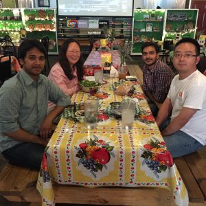 Lab members having a meal together at a long table in a restaurant