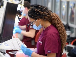 Dental students perform work at simulation lab stations