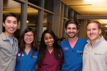 Four students pose for a photo in UMSOD's lobby